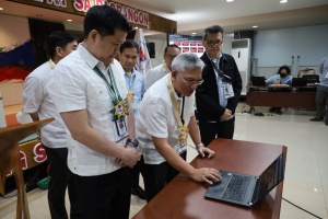 Department of Social Welfare and Development (DSWD) Secretary Rex Gatchalian observes the features of the newly-launched Finance and Management Service-For Your Information resource site as Director Wayne Belizar provides a walkthrough of the site during the project launch on Tuesday, February 14, 2023.