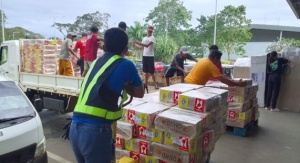 Airline personnel unload boxes of family food packs at the Cebu Pacific Cargo Office in Puerto Princesa City, Palawan.