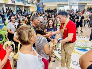 Department of Social Welfare and Development (DSWD) Secretary Rex Gatchalian greets the residents affected by the 6.0 magnitude earthquake at the financial assistance payout venue in Compostela Municipal Gym in Davao de Oro.