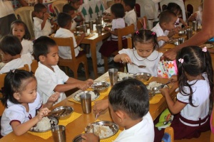 School children enjoy nutritious meal served during a supplementary feeding program