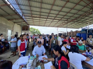 Personnel of the DSWD Field Office-3 (Central Luzon) distribute cash assistance to qualified beneficiaries during the service caravan of the DSWD and the CESB on June 15 in Sitio Paoay, Guiteb, Ramos, Tarlac.